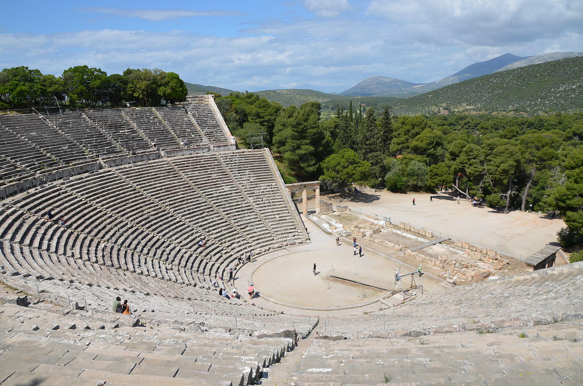 THEATER OF EPIDAURUS TO-DAY To the right, foundations of the stage building. The circle in front of it was a sort of subordinate stage for the chorus, which by songs, dances, and processions supported the action of the play.