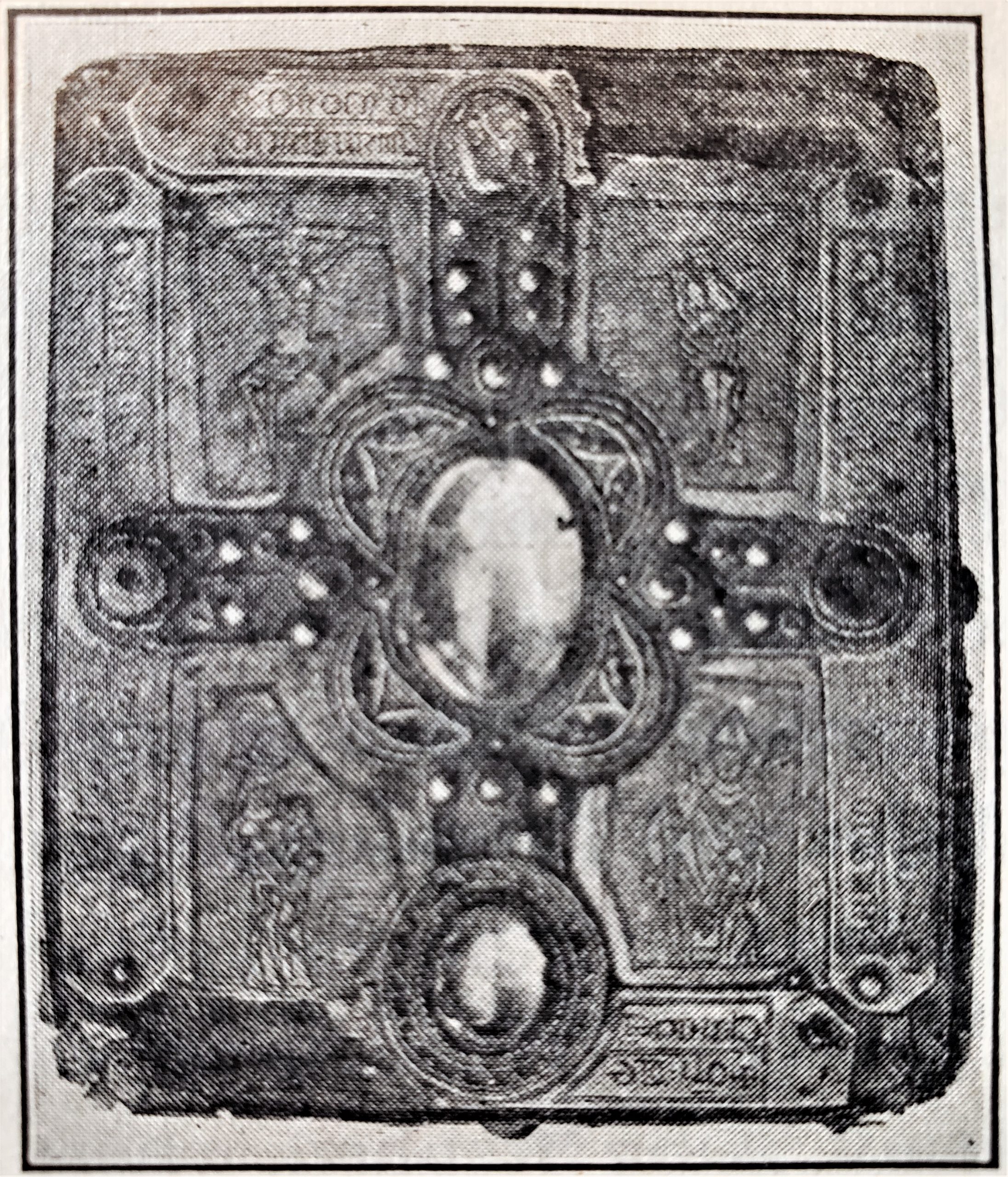 ELEVENTH-CENTURY COVER OF A MANUSCRIPT BOOK Two of the precious stones which once adorned it is still in place. Note the metal strips, the numerous minor stones, and the figures in the spaces around the center. Such elaborate covers are not rare. Wooden plates took the place of what is cardboard in present-day book covers.